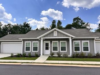A house with a grey roof and white walls